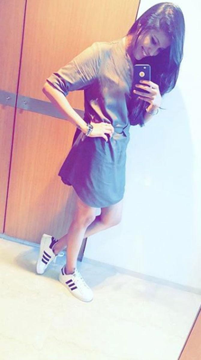 Pankhuri Sharma poses in sneakers and a short dress in this picture.