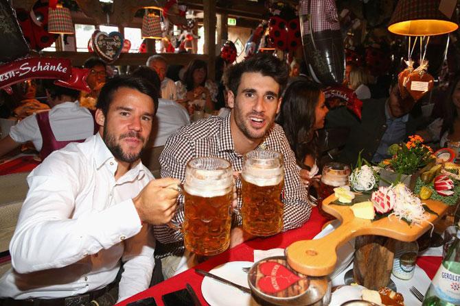 Spanish defender Juan Bernat (L) and Spanish midfielder Javier Martinez drink beer wearing traditional Bavarian outfits. Pic/AFP
