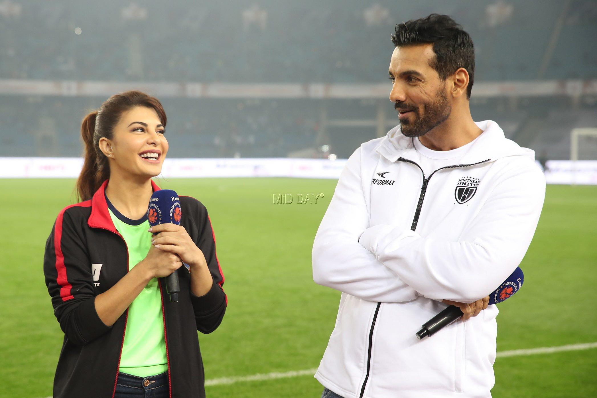 Jacqueline Fernandez and John Abraham share a light moment during the ISL match