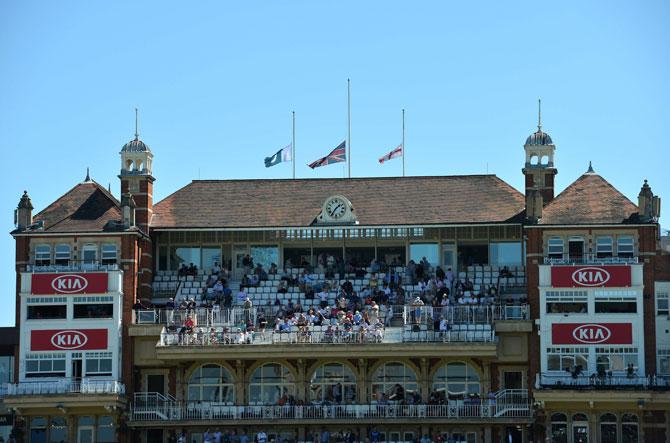 The English, British and Pakistani flags are pictured flying at half mast in memory of Pakistani cricketer Hanif Mohammad who died Thursday at the age of 81, during play on the second day of the fourth test cricket match between England and Pakistan at the Oval in London on Friday.