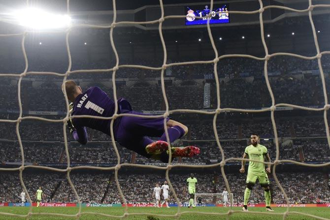 Manchester City's goalkeeper Joe Hart stops a ball