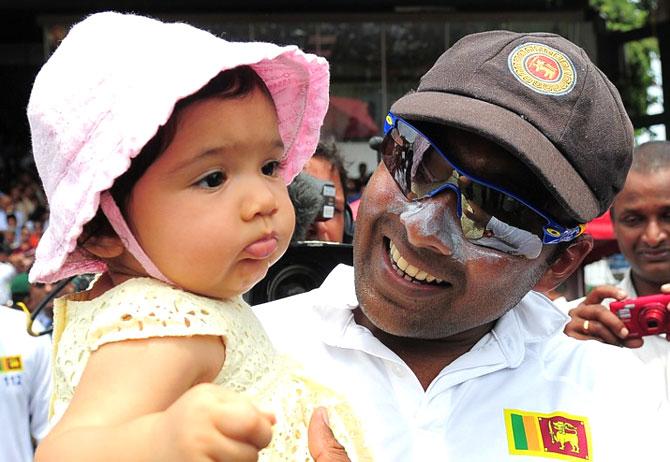 Mahela Jayawardene holds his daughter Sansana after victory in the second Test match between Sri Lanka and Pakistan at the Sinhalese Sports Club (SSC) Ground in Colombo in August 2014. Pic/ AFP