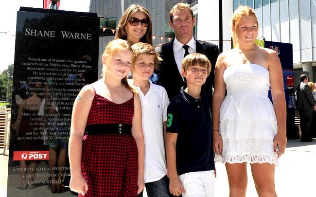 Former Australian cricket player Shane Warne (R rear) and Liz Hurley (L rear) stand with Warne's children Summer (L), Jackson (2/L), Brooke (R) and Hurley's son Damien (2/R) at the unveiling of a statue of Warne outside the Melbourne Cricket Ground (MCG), in Melbourne on December 22, 2011. Pic/ AFP