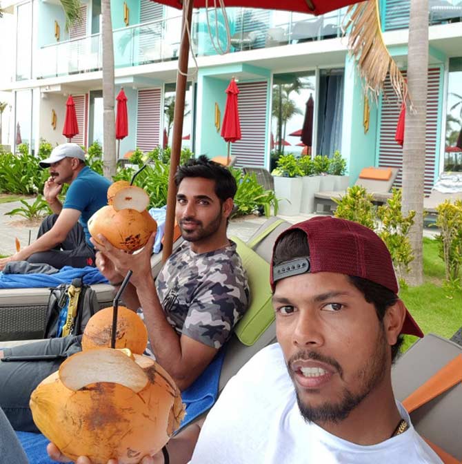 Umesh Yadav clicks a selfie with Bhunvneshwar Kumar while sipping on some coconut water