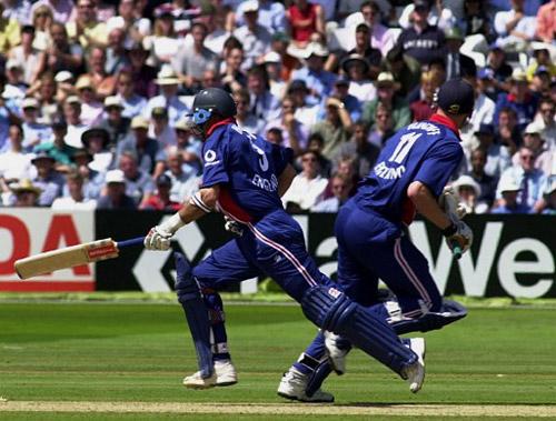 England cricket captain Nasser Hussain passes Andrew Flintoff as he reaches his century