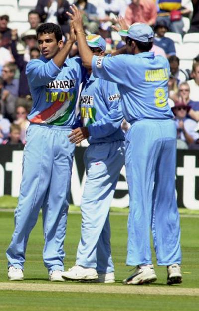 Zaheer Khan (L) of India is congratulated by teammate Anil Kumble (R) after bowling out Nick Knight of England