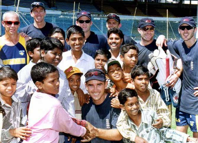 Australian players spend some time with slum childrens from Bombay after their net practice at Wankhede stadium as a part of Australian teams contribution of Rs.41.25 lakhs to the Gujrat earth quake relif fund, in Bombay on 25 February 2001.