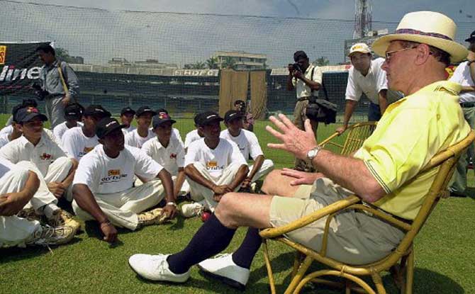 Leading cricket analyst and former British cricket player Geoffery Boycott (R) talks to young and promising cricketers in September 2000 at the Wankhede stadium in Bombay.