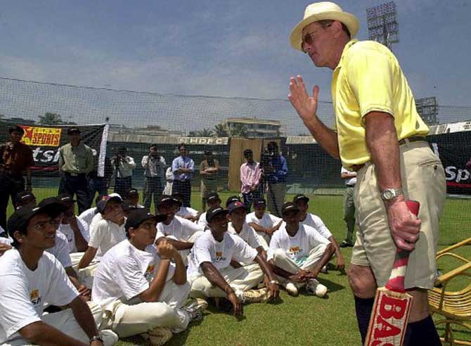 Leading cricket analyst and former British cricket player Geoffery Boycott (R) talks to young and promising cricketers in September 2000 at the Wankhede stadium in Bombay.