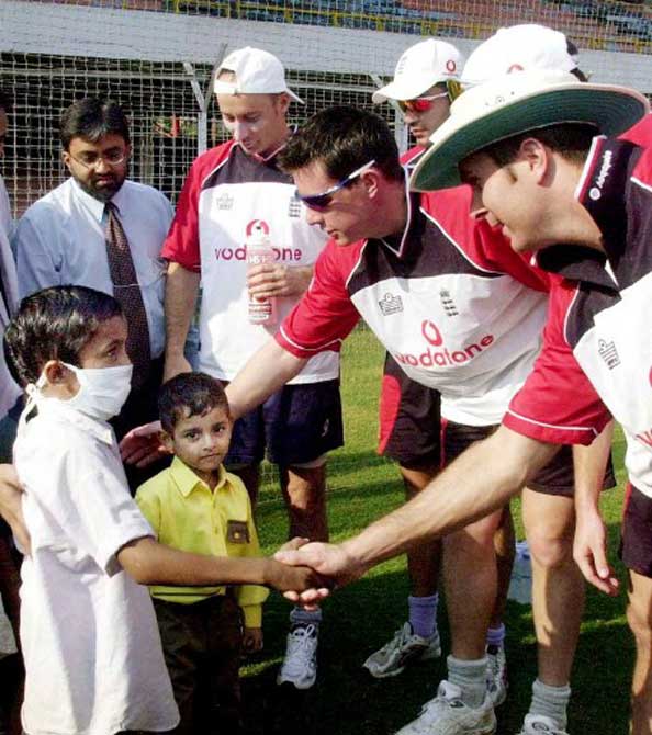 England cricketers James Ormond (R) and Michael Vaughan (2nd R) shakes hands with young cancer patients while then skipper Nasser Hussain (2nd L rear) look on at Wankhade stadium in Bombay,in November 2001. Neil Charitable Trust organised the visit by nine cancer affected children to meet the touring English cricket team.