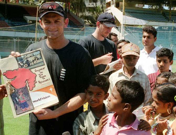 Adam Gilchrist, then Australian vice captain shows a folder which contains pictures of the February 2001 earthquake, as Michael Kasprowicz autographs for orphan children at the Wankhade stadium in Bombay.The Australian team interacted with the orphans making it a memorable day for them at the Wankhade stadium. World Vision an international relief agency brought these children to thank the Australian team for their contribution of Rs 41,25,000 to the Gujarat earthquake relief.