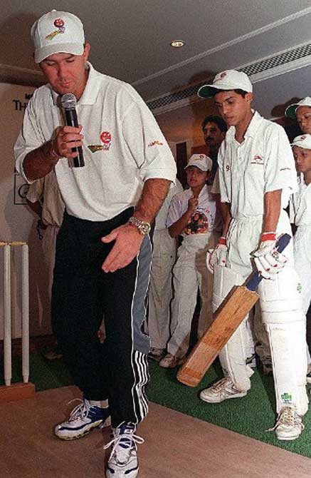 Australian cricketer Ricky Ponting (L) teaches budding cricketers in July 2000 in Bombay. Ponting at the time conducted cricket 'clinics' for boys between 16 and 19 years old in Bombay, Delhi and Bangalore in an effort to seek and nurture new talent for India's best-loved game.