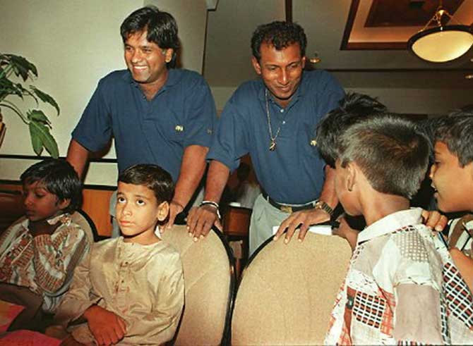 Then Sri Lankan Cricket skipper Arjuna Ranatunga (L) and Aravinda De Silva spend some time with orphan kids in a south Bombay hotel in May 1997.