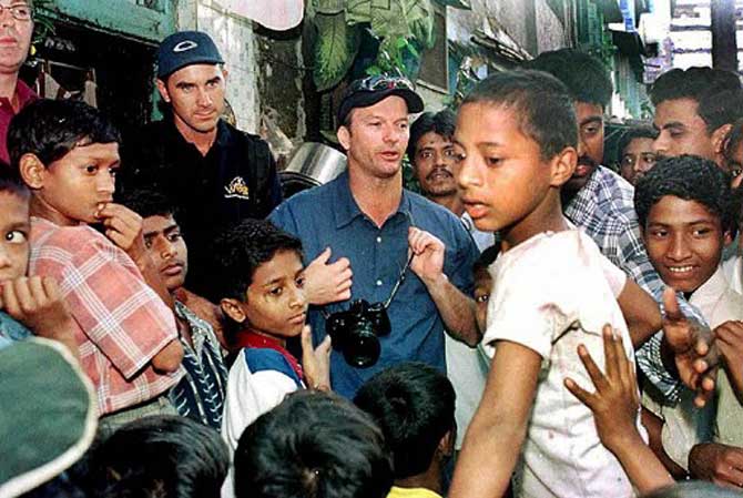 Steve Waugh visiting Kamathi the Pura Red Light area, seen with children in Bombay in February 2001.