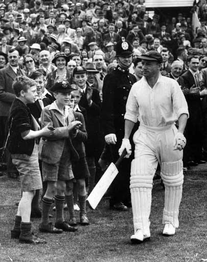 Sir Donald Bradman walking through crowds after hitting a triple century at Leeds in 1934. Pic/AFP