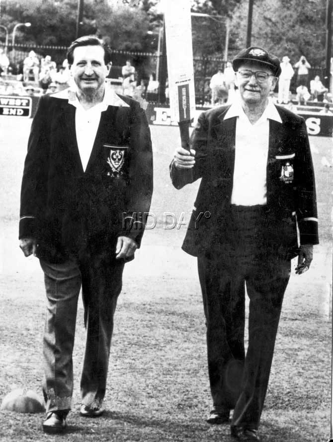 Hail the greatest! Don Bradman (r) acknowledges the crowd