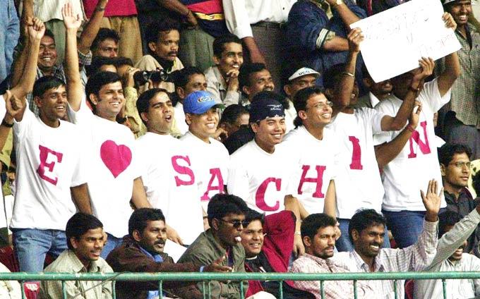 Saying it with letters: Sachin Tendulkar admirers cheering for their favourite cricketer during a Test match at Bangalore. Pic/ AFP