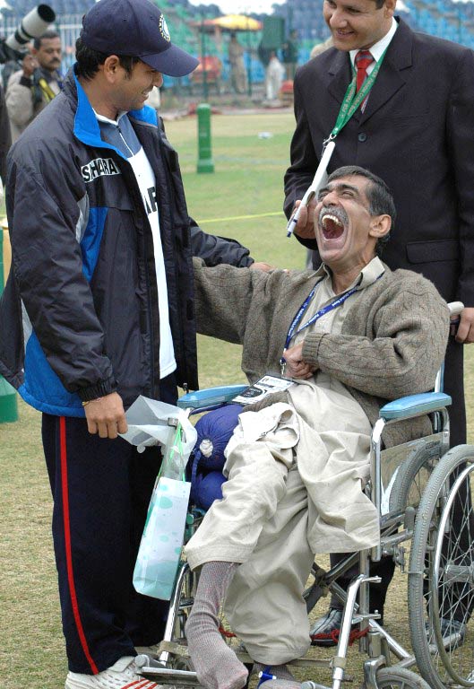 Giant, but gentle: Tendulkar shares a light moment with a disabled cricket fan at the Gaddafi Cricket Stadium in Lahore. Pic/ AFP