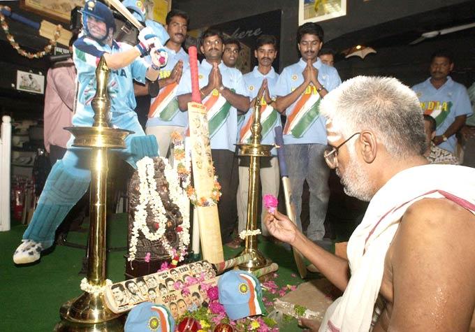 Praying for the master: A priest performs rituals in front of an idol of the Ganesha as cricket fans pray next to a cut-out of Sachin Tendulkar in Chennai. Pic/ AFP