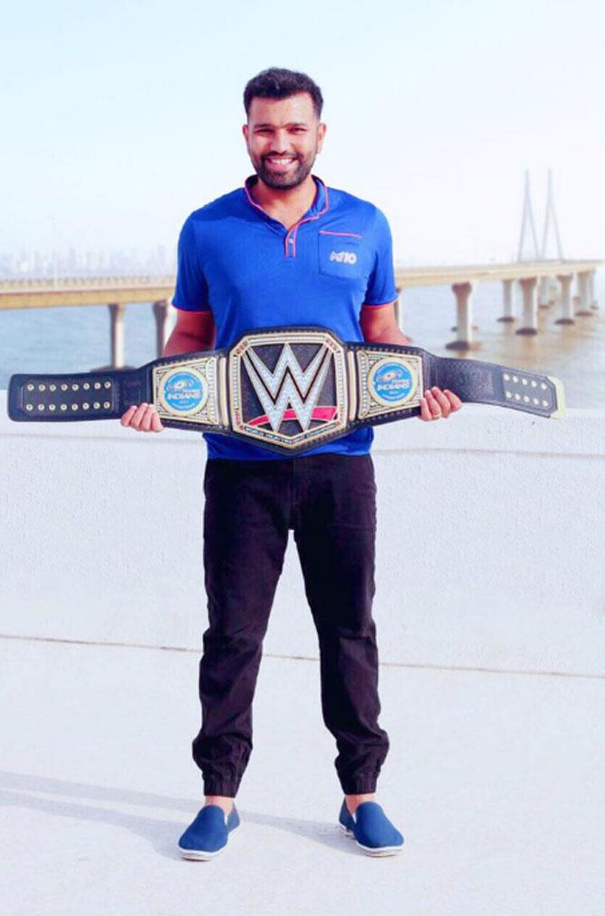 Rohit Sharma poses with the Mumbai Indians' WWE title belt that was gifted to them by WWE COO Paul 'Triple H' Levesque after they won the IPL 2017
