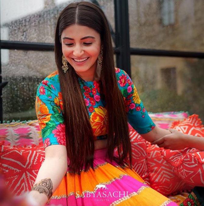 Anushka Sharma caught smiling away during her mehndi ceremony. The glint in her eyes is priceless. (Picture/ Sabyasachi Mukherjee Instagram)