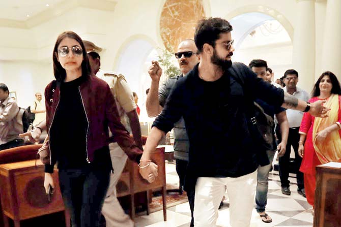 November 2016: Virat Kohli, who turned 28, landed with the rest of his team in Rajkot for the opening Test against England with his lady love Anushka Sharma firmly by his side. Kohli and Anushka emerged from Rajkot airport around noon holding hands, with the cricketer protectively guiding her through the hordes of fans and security towards a waiting car to be driven to the team hotel. The couple didn't even let go of each other's hand inside the car en route to the hotel, it is learnt. Kohli's hotel room was decorated with balloons and petals by the hotel staff, who were ready with a cake which Kohli cut with Anushka by his side along with a few close friends and teammates