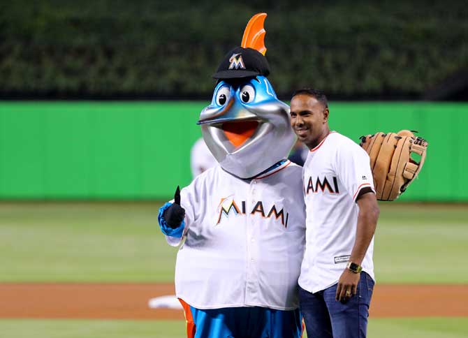 Trinidadian leg-spinner Samuel Badree poses with the Miami Marlins mascot. Pic/AFP