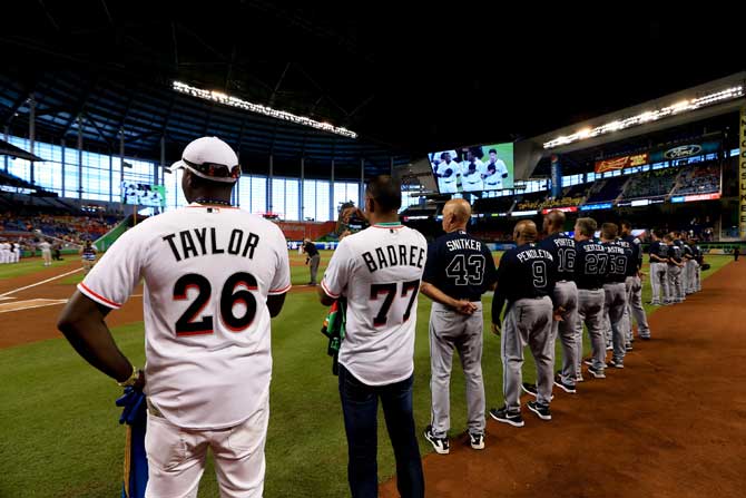 West Indies cricketer Samuel Badree looks on with USA International Steven Taylor (Barbados Tridents) after throwing out the first pitch before the game between the Miami Marlins and the Atlanta Braves at Marlins Park on Thursday in Miami, Florida. Pic/AFP