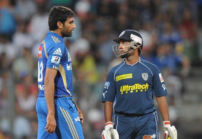 Mumbai Indians bowler Munaf Patel (L) argues with Deccan Chargers batsman Amit Mishra (R) during a match at the Wankhede Stadium in Mumbai on May 14, 2011. Pic/ AFP