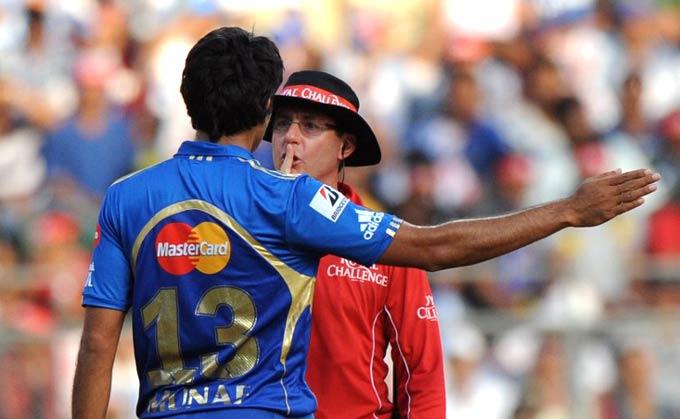 Mumbai Indians bowler Munaf Patel is cautioned by umpire Rod Tucker after a verbal spat with Kings XI Punjab batsman Mandeep Singh during a match at the Wankhede Stadium in Mumbai on April 22, 2012. Pic/ AFP