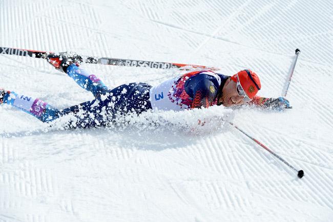 Gold medalist Russia's Alexander Legkov lies in the snow after crossing the finish line in the Men's Cross-Country Skiing 50km Mass Start Free (AFP)