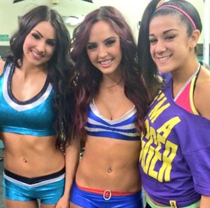 In picture: Bayley with her NXT friends Billie Kay and Peyton Royce known as The IIconics