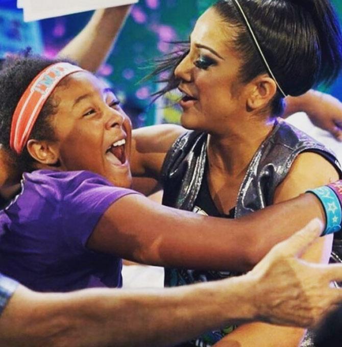 In picture:  Bayley hugs a fan. She was famously known as a 'hugger' for the initial part of her WWE career with her fun-loving persona