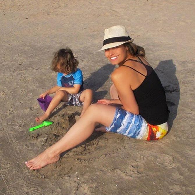 Trish Stratus with her son. She captioned it: We built a killer sandcastle. It even had a moat. #mylegsarereallyuntanned .#maxstratus #3yearsold #beachlife #cottagelife #sandcastles #moat